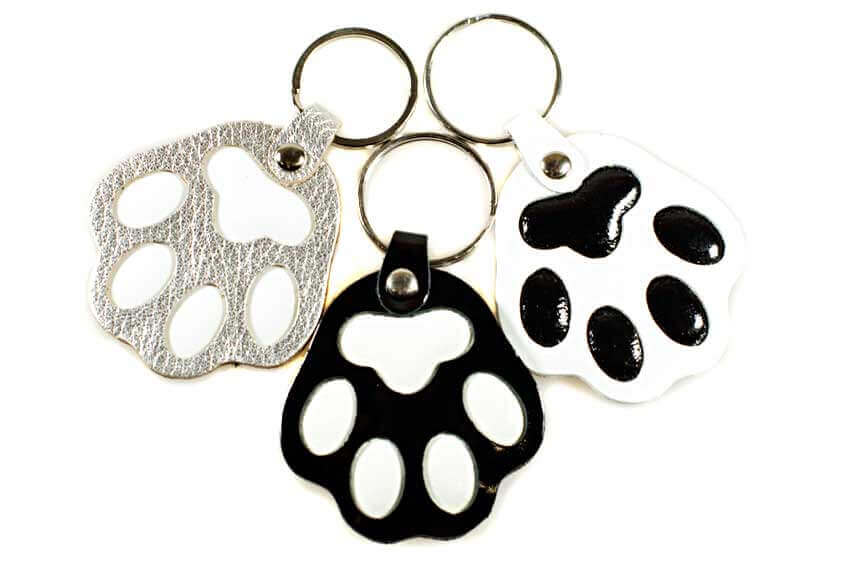 Silver, black and white dog paw key rings