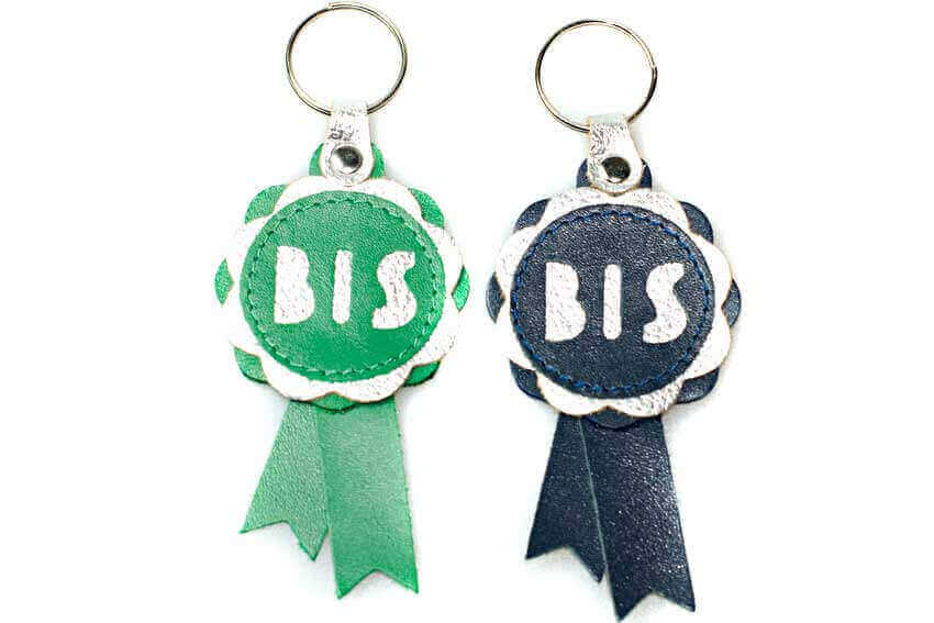 Show rosette key rings in navy blue and emerald green